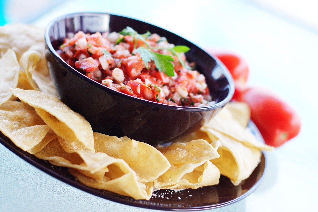 Tortilla chips beside a bowl of fresh pico de gallo